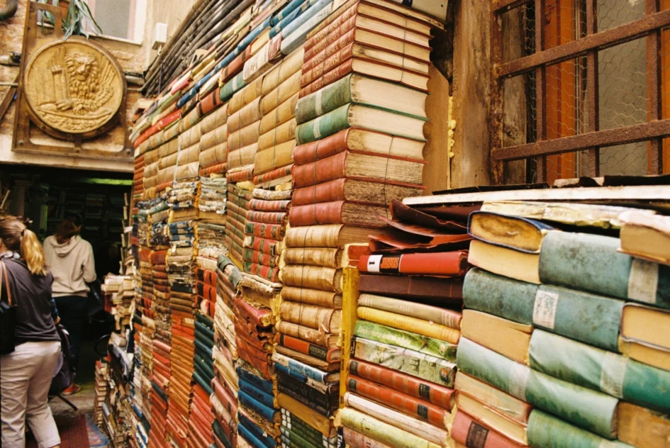 An image of a large stack of books in a room.