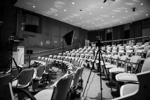 A black and white shot of an empty lecture theatre in Trinity College Dublin during filming of the documentary.